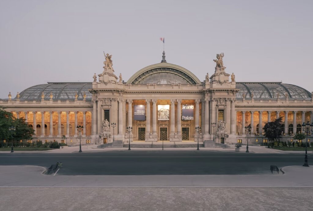 A wide-angle photo of the newly renovated Grand Palais in Paris showcasing its restored glass roof and Beaux-Arts architecture